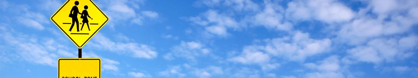 school zone sign with blue sky background